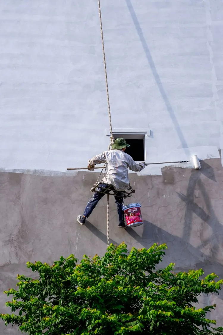 Painter painting an interior wall